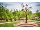 Scenic park view showcasing artistic birdhouse sculpture, landscaped greenery and walking path for serene neighborhood enjoyment at 2511 Kestrel Heights Ct Ct, Durham, NC 27703