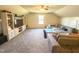 Spacious bonus room featuring vaulted ceilings, plush carpeting, and a large sectional sofa for relaxation and entertainment at 2511 Kestrel Heights Ct Ct, Durham, NC 27703