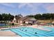 Community clubhouse with a sparkling pool, sundeck, and lounge chairs for residents to enjoy resort-style amenities at 2511 Kestrel Heights Ct Ct, Durham, NC 27703