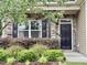 Charming front porch with stone detailing, black shutters and lush greenery for a warm welcome at 2511 Kestrel Heights Ct Ct, Durham, NC 27703