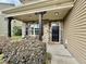 Inviting front porch with stone accents, black door, and manicured landscaping for curb appeal at 2511 Kestrel Heights Ct Ct, Durham, NC 27703