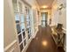 Elegant hallway features hardwood floors, white trim, and French doors leading to other rooms at 2511 Kestrel Heights Ct Ct, Durham, NC 27703
