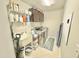 Laundry room with utility sink, wire shelves, tile flooring, and newer appliances at 2511 Kestrel Heights Ct Ct, Durham, NC 27703
