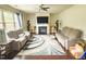 Spacious living room with a fireplace, ceiling fan, hardwood floors, and two sofas at 2511 Kestrel Heights Ct Ct, Durham, NC 27703