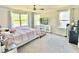 Bright main bedroom with carpet, ceiling fan, TV, and lots of natural light at 2511 Kestrel Heights Ct Ct, Durham, NC 27703