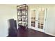 Cozy office space with natural light, French doors, and a shelving unit for organized storage at 2511 Kestrel Heights Ct Ct, Durham, NC 27703