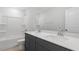 Bathroom featuring dual sinks, gray vanity, white countertop, and large mirror at 257 North Maple Walk Dr # 218, Garner, NC 27529