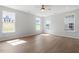Bright bedroom featuring hardwood floors, multiple windows, and a ceiling fan for comfortable living at 257 North Maple Walk Dr # 218, Garner, NC 27529