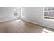 Bright bedroom features hardwood floors and natural light from multiple windows at 257 North Maple Walk Dr # 218, Garner, NC 27529