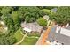 Aerial perspective of a stately brick home with manicured landscaping, a detached garage, and a circular driveway at 2608 York Rd, Raleigh, NC 27608