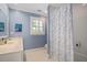 Bathroom features white tile, blue walls, a vanity and blue/white shower curtain at 2608 York Rd, Raleigh, NC 27608
