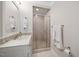 Bathroom featuring a glass enclosed shower, vanity with quartz countertop, and decorative mosaic tile backsplash at 2608 York Rd, Raleigh, NC 27608