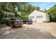 Large driveway with two cars parked in front of a detached two-car garage at 2608 York Rd, Raleigh, NC 27608
