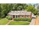 Traditional red brick home with manicured landscaping, dormer windows, and a long driveway at 2608 York Rd, Raleigh, NC 27608