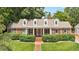 Traditional brick home with white columns, dormer windows, and manicured landscaping at 2608 York Rd, Raleigh, NC 27608