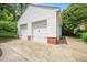 Detached two-car garage with white siding and brick accents on a concrete driveway at 2608 York Rd, Raleigh, NC 27608