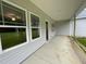Covered back porch with concrete floors and view of the green backyard at 268 Busterfield Ct, Benson, NC 27504