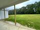 Covered porch with view of the expansive, lush green backyard and wooded area at 268 Busterfield Ct, Benson, NC 27504