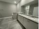 Spacious bathroom boasts a double sink vanity with granite countertop and tiled floors at 268 Busterfield Ct, Benson, NC 27504