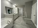 Bathroom with a large vanity with granite countertops, a tub, and tiled floors at 268 Busterfield Ct, Benson, NC 27504