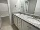 Bathroom showcasing a granite countertop vanity and a shower tub combo, offering functionality at 268 Busterfield Ct, Benson, NC 27504