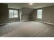 Spacious bedroom with two windows, featuring plush carpeting and neutral paint at 268 Busterfield Ct, Benson, NC 27504
