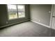 Bedroom featuring a window overlooking a neighborhood home, adding to the cozy feel at 268 Busterfield Ct, Benson, NC 27504