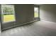 Bedroom featuring two windows overlooking a green lawn, enhancing the living space at 268 Busterfield Ct, Benson, NC 27504
