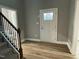 New entryway featuring vinyl wood flooring, a white door, and an open staircase at 268 Busterfield Ct, Benson, NC 27504