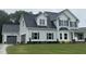 Charming two-story home with gray siding, a dark roof, and an attached two car garage at 268 Busterfield Ct, Benson, NC 27504