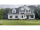 Two-story home featuring gray siding, a dark roof, and a well-manicured lawn at 268 Busterfield Ct, Benson, NC 27504