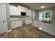 Modern kitchen featuring white cabinets, granite countertops, and stainless steel microwave at 268 Busterfield Ct, Benson, NC 27504