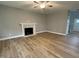 Cozy living room features hardwood floors, a ceiling fan, and a marble fireplace at 268 Busterfield Ct, Benson, NC 27504