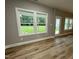 Bright living room featuring large windows and a glass door leading to the outside at 268 Busterfield Ct, Benson, NC 27504