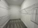 Walk-in closet with installed shelving and carpet flooring, providing storage at 268 Busterfield Ct, Benson, NC 27504