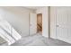 Neutral bedroom showcasing carpet, two white doors, and electrical outlets at 2700 Barrington Dr, Raleigh, NC 27610