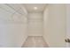 A well-lit, carpeted walk-in closet with metal shelving for organization and storage at 2700 Barrington Dr, Raleigh, NC 27610