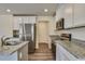 Well-lit kitchen featuring white cabinets, stainless steel appliances, and granite countertops at 2700 Barrington Dr, Raleigh, NC 27610