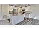 Modern kitchen with white cabinets, stainless steel appliances, and a granite-topped island at 2700 Barrington Dr, Raleigh, NC 27610
