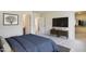 Spacious main bedroom featuring a TV, dresser, closet and neutral color palette at 2700 Barrington Dr, Raleigh, NC 27610