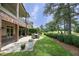 Landscaped backyard with brick patio, dining area, and well-maintained lawn at 2800 Charleston Oaks Dr, Raleigh, NC 27614