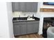 Wet bar featuring granite countertop, gray cabinets, and proximity to a cozy fireplace at 2800 Charleston Oaks Dr, Raleigh, NC 27614