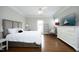 Comfortable bedroom featuring hardwood floors, a dresser and neutral tones at 2800 Charleston Oaks Dr, Raleigh, NC 27614