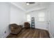 Bright bedroom with hardwood floors, tray ceiling, and comfortable seating area with two armchairs at 2800 Charleston Oaks Dr, Raleigh, NC 27614
