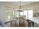 Bright dining area features a white table and chairs, pendant lighting, and access to an outdoor patio at 2800 Charleston Oaks Dr, Raleigh, NC 27614