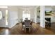 Elegant dining room with hardwood floors, stylish chandelier, and adjacent living spaces at 2800 Charleston Oaks Dr, Raleigh, NC 27614