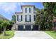 Attractive three-story home with three-car garage, manicured lawn, and classic architectural details at 2800 Charleston Oaks Dr, Raleigh, NC 27614