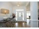 Bright foyer featuring hardwood floors, white trim, and an elegant front door at 2800 Charleston Oaks Dr, Raleigh, NC 27614