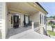 Stylish front porch with neutral tones, black seating, and an elegant glass front door at 2800 Charleston Oaks Dr, Raleigh, NC 27614