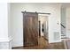 Hallway features a sliding barn door leading to the kitchen with stainless steel appliances at 2800 Charleston Oaks Dr, Raleigh, NC 27614